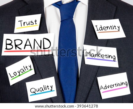 Photo of business suit and tie with BRAND concept paper cards