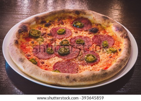 Pizza Salami on a wooden table