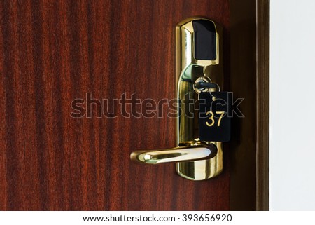Half opened door of a room with number 37 on it. Hotel room door with lock half open. Hotel suit welcome guests. Opening door closeup. Door handle. Privacy concept. Entrance to the hotel room. 