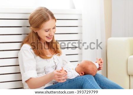 happy family. mother plays and laughs with her newborn baby