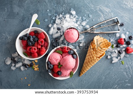 Raspberry ice cream in white bowl overhead shot Royalty-Free Stock Photo #393753934