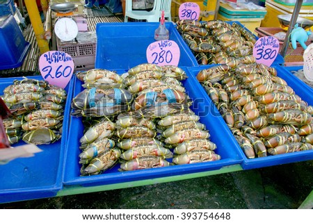 Live black crabs ready to be cooked in fresh market at Thailand. (Text in signs mean Black Crab or Serrated Mud Crab)