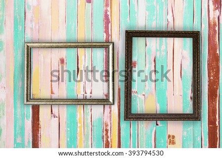 couple old blank frame on vintage colorful wooden wall background