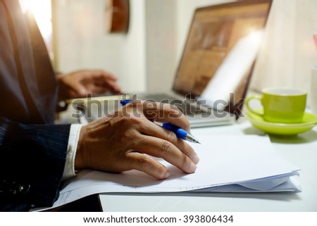 Business man signing or working a  documents.