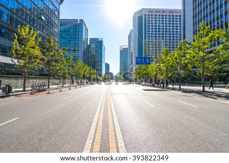 city road through modern buildings in beijing Royalty-Free Stock Photo #393822349