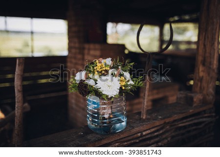 Wedding bouquet in a plastic bottle on a background of rustic arbor