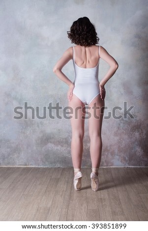 Ballerina in a white bathing suit with a beautiful body standing on pointe shoes, lifestyle, hobbies, dancing, choice
