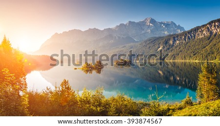 View of the islands and turquoise water at Eibsee Lake at the foot of Mt. Zugspitze. Morning scene. Location famous resort Garmisch-Partenkirchen, Bavarian alp, Europe. Artistic picture. Beauty world.