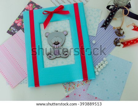 Hand-made picture with wooden colorful frame, stripes and bear. Top view