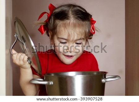 Portrait of cute little girl cooking soup in the kitchen, food and drink concept, indoor