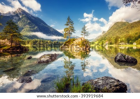 View on turquoise water and scene of trees on a rock island at Lake Hintersee. Location famous resort National park Berchtesgadener Land, Ramsau, Bavaria, Alps. Europe. Artistic picture. Beauty world.