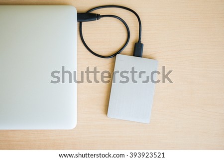 External hard drive connected to laptop computer