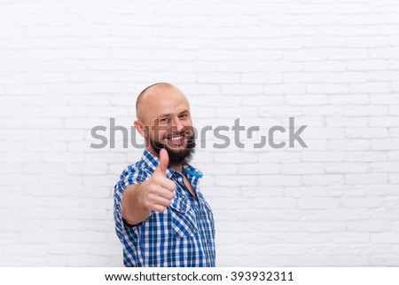 Casual Bearded Man Thumb Up Hand Gesture Smiling Over White Brick Wall