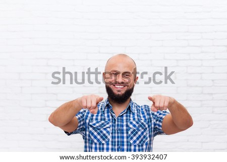 Casual Bearded Business Man Smiling Point Fingers At You Over White Brick Office Wall