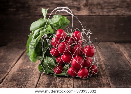 Fresh rustic harvest of radishes healthy vegetables in vintage basket background