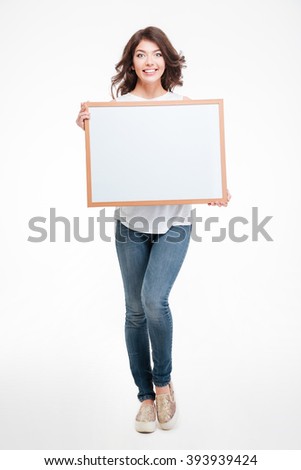 Full length portrait o a happy woman holding blank board isolated on a white background