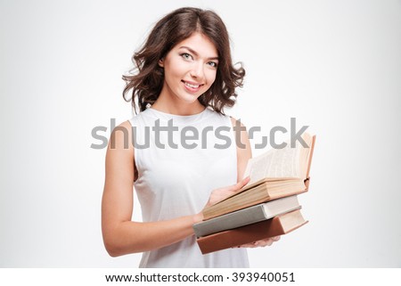 Smiling woman holding paper books isolated on a white background and looking at camera
