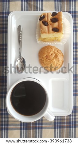 The coffee break, cookie and black coffee on white tray.