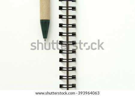 open white book on isolate white background with pen Royalty-Free Stock Photo #393964063