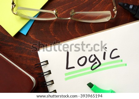 Logic written in a notepad on a wooden background.