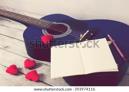 Vintage tone:guitar,Heart,Book,Pencil on wood table