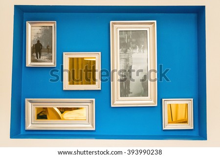 Decorative Blue Wall with Frames and Mirrors