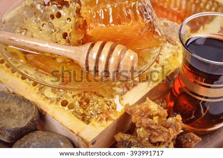 fresh  honeycombs  and wooden stick ,cup of Turkish tea,propolis, isolated on white background