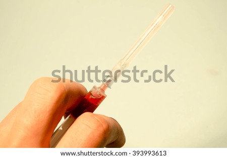 Hand in holding syringe