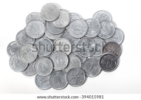 Pile of 1 yen coins japanese money, close up on white background.