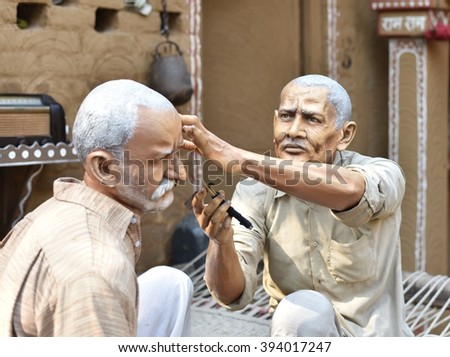Statue made of clay - India Barber making shave of another man