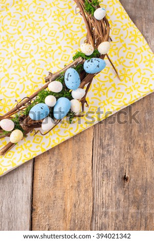 Easter Decoration. easter wreath, with hand painted easter eggs, on the vintage wooden background. easter theme. Easter egg wreath on a wooden background