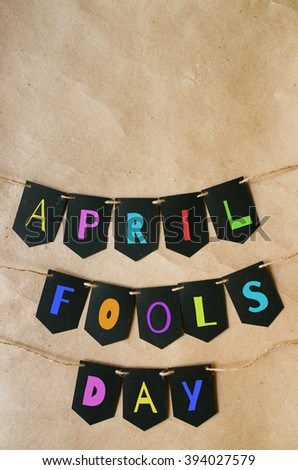 Happy april fools day banner lettering on craft paper background. Space for text, copy. Greeting postcard template.