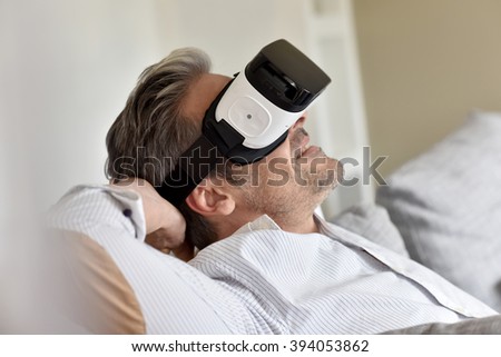 Closeup of man using virtual reality headset, VR mask