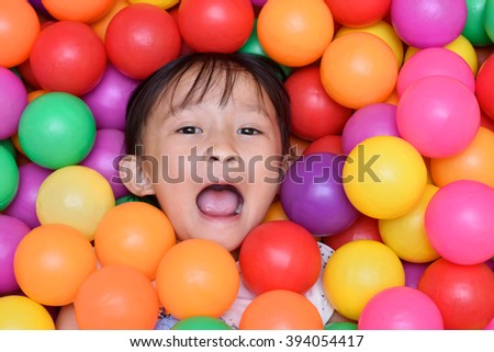 Cute asian girl in ball room playground.