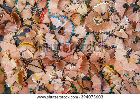 Background of multicolor pencil shavings. Close up colorful pencil shavings for background. Dynamic, abstract, horizontal composition of pencil sharpening shavings, close up, macro