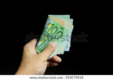 Male hand holding euro money banknotes