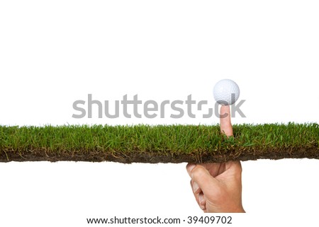 Golf-ball on a finger from the side on turf
