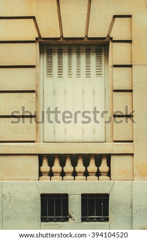 Classic sandstone wall with sealed metal window. Vintage effect.
