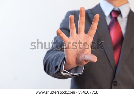 Businessman pinching in the air with five fingers - Digital and imagination concept