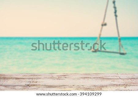Wooden empty shelves for presentation or background blur with a view of the sea and have a swing