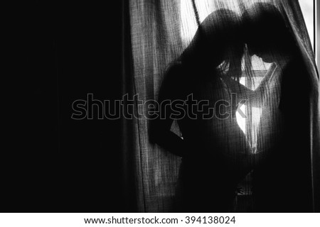 Silhouette beautiful pregnant woman and man holding hands on a child, a cozy portrait of a beautiful mother