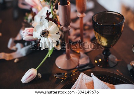Wedding. Decor. Serving. Artwork. Banquet table for two served and decorated with candles, flowers and napkins