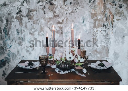Wedding. Decor. Serving. Artwork. Banquet table for two served and decorated with candles, flowers and napkins