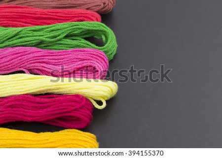 Threads for sewing on a black background
