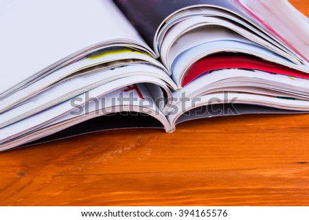 Stack of magazines on a wooden background