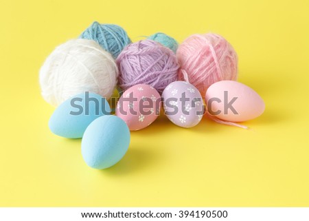 Pastel and colored Easter eggs and wool clew
