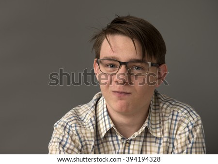 Portrait of a happy teenager boy with glasses