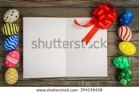Easter eggs gift card on wooden background