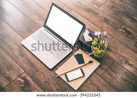 Modern Laptop with blank screen and mobile smartphone, designer workspace