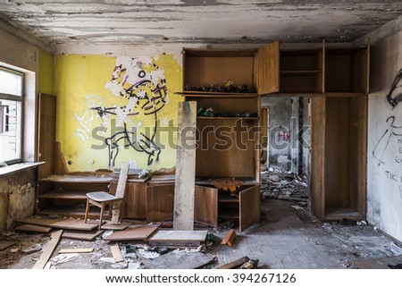Abandoned messy room with broken wooden furnitures